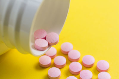 Close-up of medicines over colored background