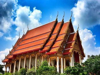 Low angle view of roof of building against cloudy sky