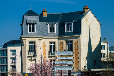 Low angle view of buildings against blue sky