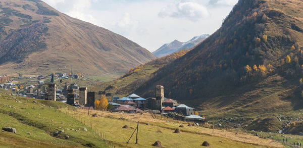 Panoramic view of houses and mountains against sky