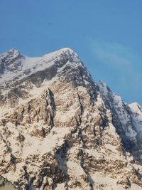 Scenic view of snowcapped mountains against clear blue sky