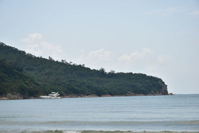 Scenic view of sea and mountains against sky