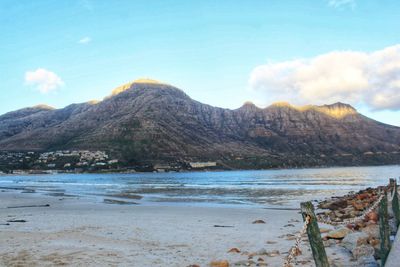 Scenic view of sea and mountains against sky