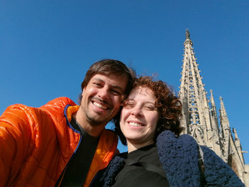 Couple selfie with barcelona cathedral in the background.