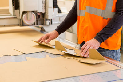 Cropped image of man working on table