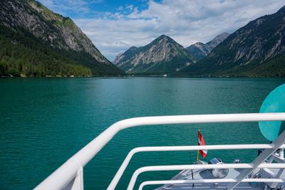 Scenic view of lake by mountains against sky