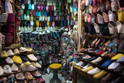 Multi colored shoes for sale at market stall