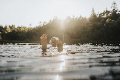 Senior woman swimming in lake