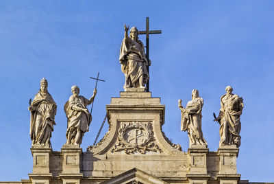 Low angle view of statue against blue sky