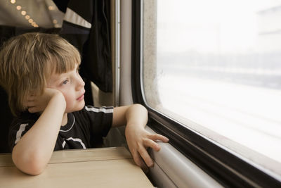 Boy looking through train window, sweden