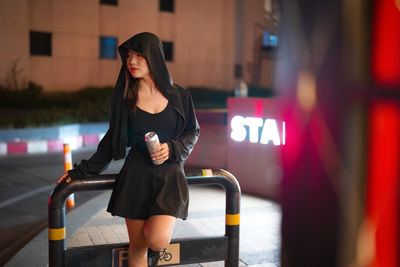 Side view of young woman standing in gym