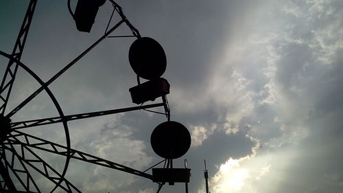 Low angle view of street light against cloudy sky