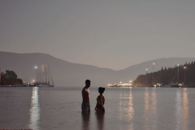 Friends enjoying in water against sky