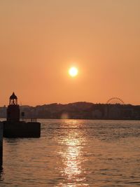 Scenic view of sea against orange sky