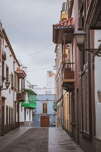 Las palmas, spain, 31st march 2022 - street with buildings and people during a sunny day 