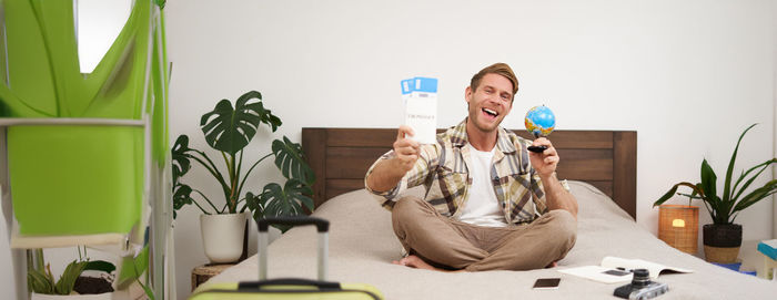Portrait of young woman using mobile phone at home