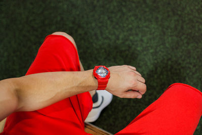 Low section of man wearing wristwatch