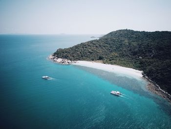 High angle view of boats sailing in sea against clear sky