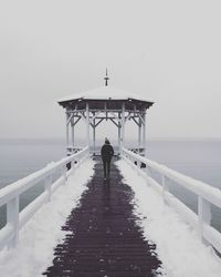 Pier over sea against clear sky