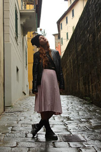 Full length rear view of woman walking on street