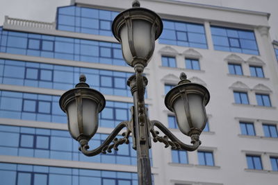 Low angle view of street light against building