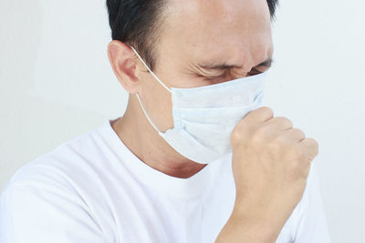 Close-up portrait of man against white background