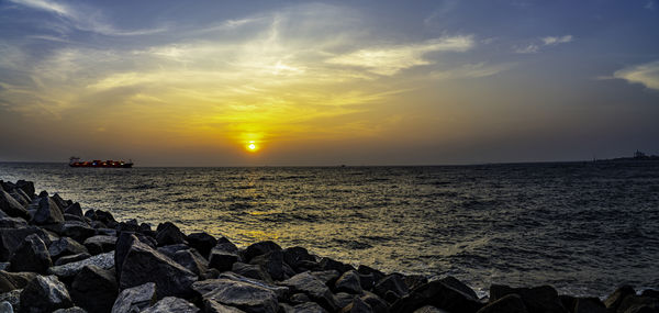 Fort kochi costal cost of arabian sea cargo ship during mystic sunset panoramic view