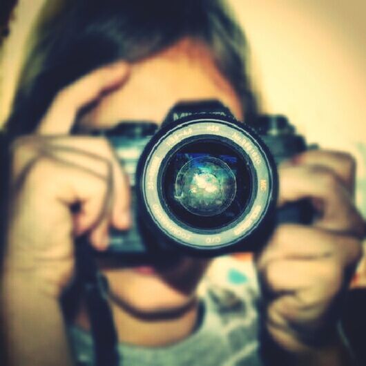 MAN PHOTOGRAPHING THROUGH CAMERA