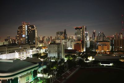 High angle view of illuminated buildings in city at night