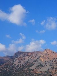 View of desert against cloudy sky