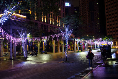 People on illuminated city at night