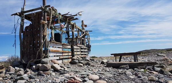 Traditional windmill on beach against sky