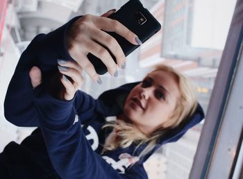 Close-up of woman taking selfie with mobile phone