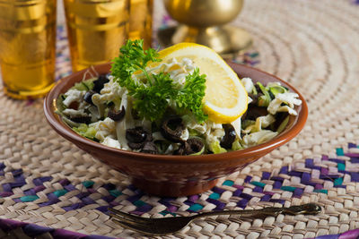 Close-up of salad in bowl on place mat