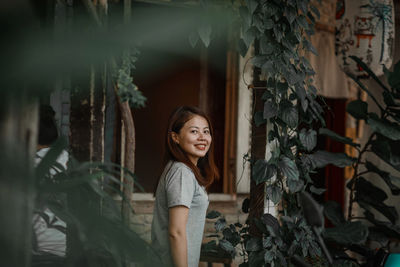 Portrait of smiling young woman standing outdoors