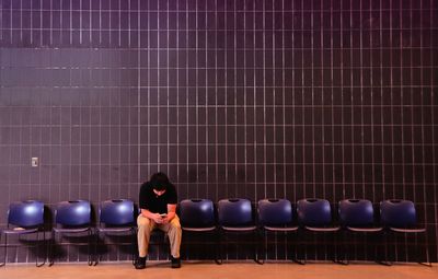 Man using smart phone while sitting on chair