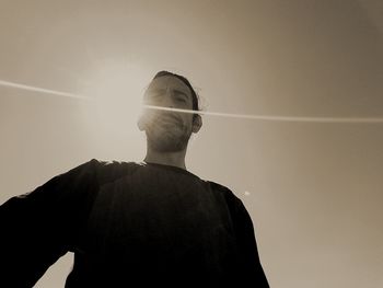 Low angle view of man standing against sky