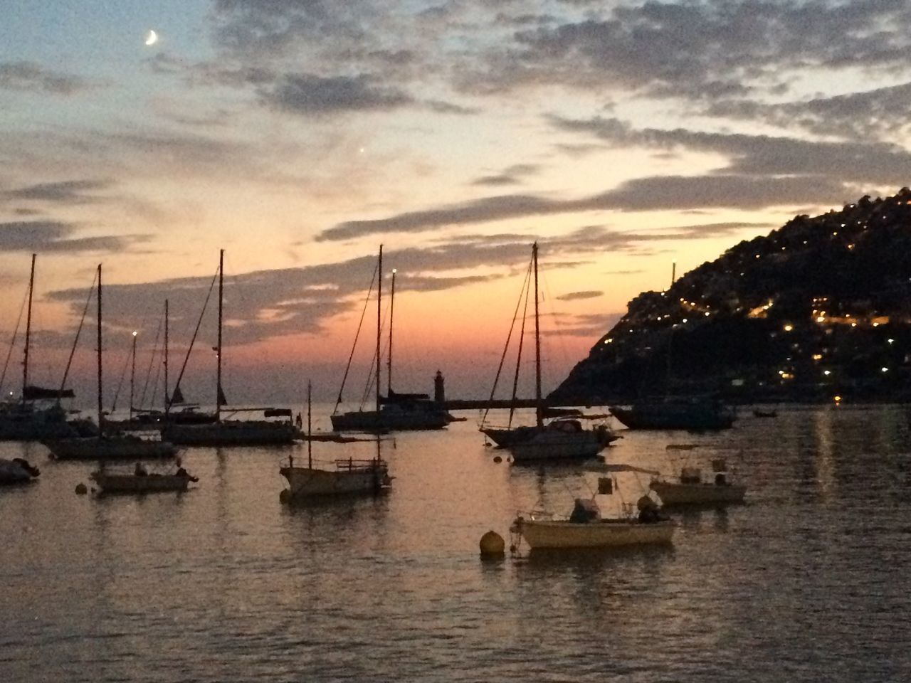 SAILBOATS MOORED IN HARBOR