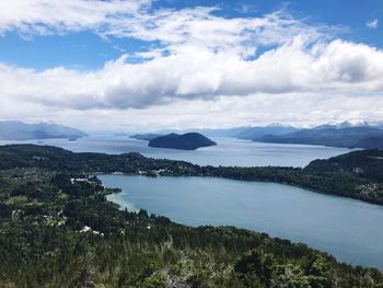 Scenic view of sea and mountains against sky