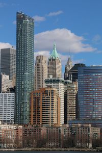 Low angle view of skyscrapers against blue sky