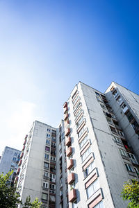 Low angle view of modern buildings against clear blue sky