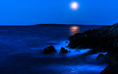 Scenic view of sea against clear blue sky