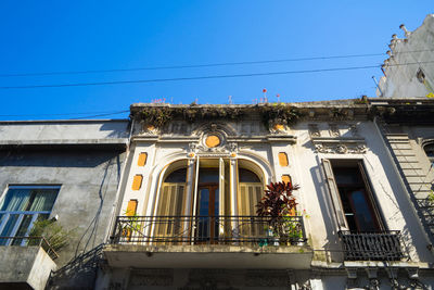 Low angle view of building against clear blue sky