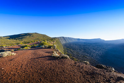 Landscape with cliffs of the volcanic area at reunion island with a blue sky