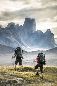 Two climbers hike toward mount asgard in akshayak pass