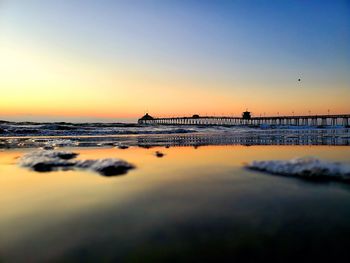 Scenic view of sea against romantic sky at sunset