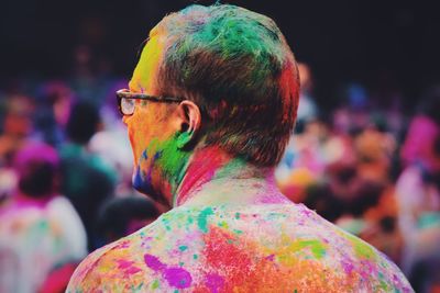 Close-up of colorful man during holi