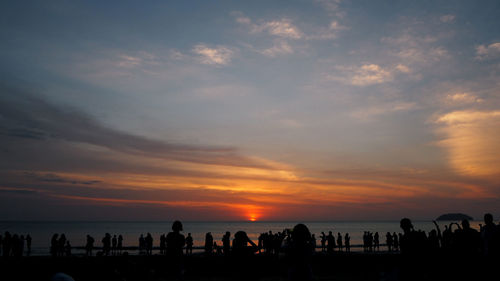 Silhouette of people on beach during sunset