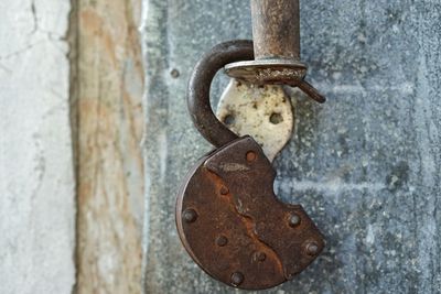 Close-up of rusty padlock on door