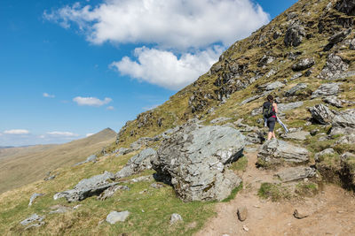 Young female hiker between rocks on ben lawers hike